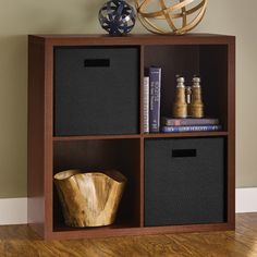 a wooden shelf with baskets and books on it