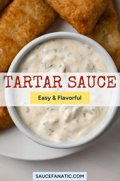 a white plate topped with tater tots next to a bowl of ranch sauce