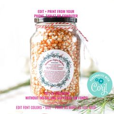 a jar filled with lots of food sitting on top of a white table next to a plant