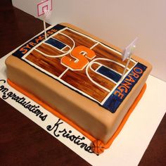 a cake that is sitting on top of a table with a basketball court in the middle