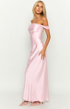 Light Pink Off Shoulder Formal Dress  How to style: Our popular Ella maxi dress now comes in a stunning light pink. Perfect for you next formal () or prom event, you're guaranteed to turn heads. Pair with gold jewellery () and pink heels () to elevate this look.  Features:     * Light weight satin material   * Maxi length   * Slight stretch   * Bias cut   * Off the shoulder style   * Fully lined   * Invisible zip on left side   * Grip on inner bust Off The Shoulder Maxi Dresses, Long Silk Pink Dress, Form Fitting Formal Dress, Light Color Prom Dress, Fun Prom Dresses Long, Homecoming Dresses Maxi, Formal Wedding Guest Dress Pink, Prom Summer Dresses, Light Pink Classy Dress