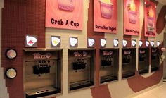 a row of vending machines sitting next to each other in front of a wall