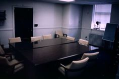 an empty conference room with chairs and a large table