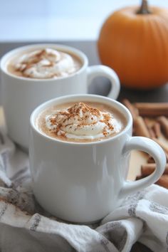 Two mugs of frothy spiced latte topped with cinnamon, with a pumpkin and cinnamon sticks in the background. Pumpkin Spice Latte Syrup, Holiday Side Dishes Christmas, Diy Pumpkin Spice Latte, Pumpkin Starbucks, Stuffing Balls Recipe, Pumpkin Spice Latte Recipe, Easy Holiday Side Dishes, Spiced Whipped Cream, Homemade Pumpkin Spice Latte