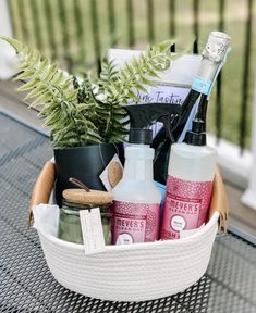 a basket filled with personal care items sitting on top of a table next to a potted plant