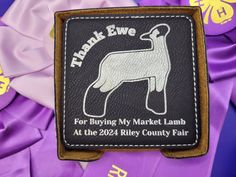 a patch with a dog on it that says thank ewe for buying my market lamb at the 2021 riley county fair