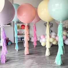 balloons and tassels are on display in a room