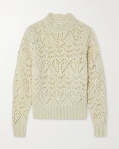 a white sweater with an openwork pattern