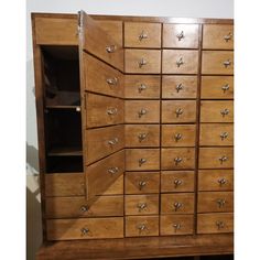 a large wooden cabinet with many drawers