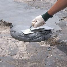 a person in white gloves is using a trowel