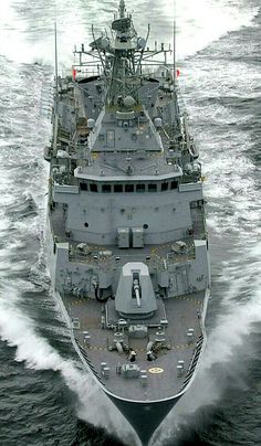 an aerial view of a navy ship in the water