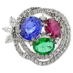 A Ruby, Emerald, Sapphire and Diamond Cocktail Ring made in 18k White Gold. The Oval Sapphire weighs appx. 2 carats, oval emerald appx. 0.20 cts. and ruby appx 1.20 carats. accented by round brilliant and marquise cut diamonds. The total weight of the ring is 9.06 grams. Ring Size 6.50 US. SKU: 1449 Diamond Cocktail Ring, Ruby Emerald, Diamond Cocktail Rings, Marquise Cut Diamond, Gem Stone, Marquise Cut, 2 Carat, Sapphire Diamond, Cocktail Ring