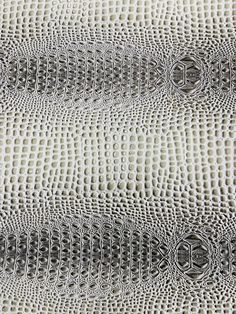 an up close view of the surface of a white fabric with black circles on it