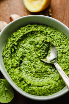 a white bowl filled with green pesto