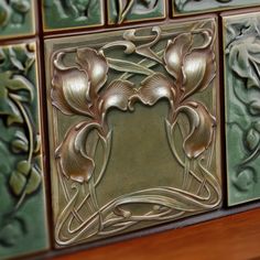 decorative tiles with flowers and vines on them