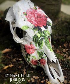 an animal skull with flowers painted on it