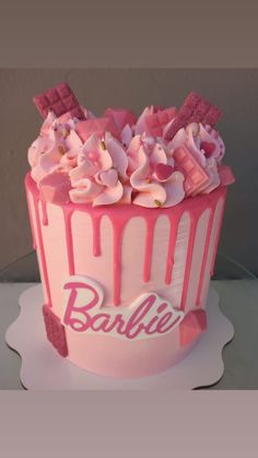 a cake with pink icing and flowers on the top that says babbler