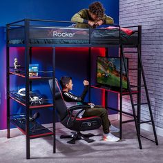 a young boy sitting on top of a bunk bed next to a desk and chair