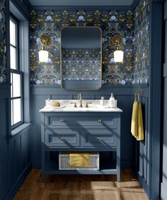 a bathroom with blue walls and wood flooring, two mirrors on the wall above the sink