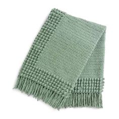 a light green scarf with fringes on the bottom and one section folded in half