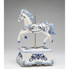 a white and blue horse figurine sitting on top of a table