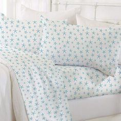 a white bed with blue stars on it