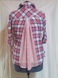 a mannequin wearing a pink and blue plaid shirt with lace on the collar