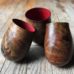 three wooden cups sitting on top of a wooden floor