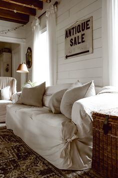 a living room filled with furniture and pillows