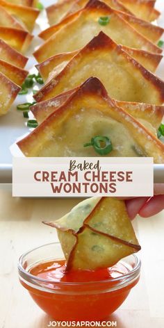 a person dipping cheese wontons into a bowl with ketchup on the side