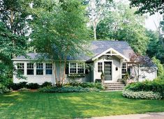 a white house surrounded by trees and grass