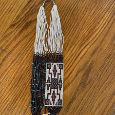 This Unique Necklace Showcases The Rich Cultural Heritage Of The Navajo People. The Handcrafted Beaded Design Features Turquoise, Shells, And Seed Beads In A Stunning White, Brown And Black Palette. The Necklace Is 31 Inches Long And Secured With A 925 Sterling Silver Clasp.Perfect For Graduation Or Any Special Occasion, This Unisex Necklace Is A Rare Find That Will Add A Touch Of Ethnic And Regional Style To Any Outfit. The Woven Design Adds An Extra Layer Of Complexity And Elegance To The Piece, Making It A True Work Of Art. Don't Miss Out On The Opportunity To Own This Exquisite Native American Necklace. It Was Purchased Onsite At Canyon De Chellyin The Mid 90s. Southwestern Style White Beaded Necklace With Large Beads, Southwestern Style Large White Beads, White Southwestern Hand-strung Necklaces, Southwestern Style Hand-strung White Necklaces, Southwestern White Hand-strung Beaded Necklace, White Southwestern Hand-strung Beaded Necklace, White Hand-strung Southwestern Necklace, Southwestern Style Hand-strung White Beads, Hand-strung White Southwestern Necklace