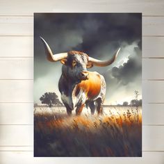 a painting of a longhorn bull in a field with storm clouds behind it, on a wooden wall