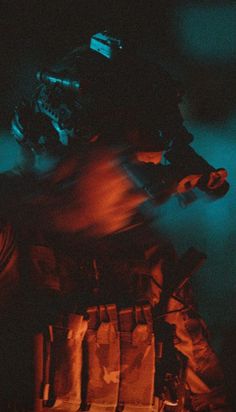 a man riding a snowboard on top of a pile of skis in the dark