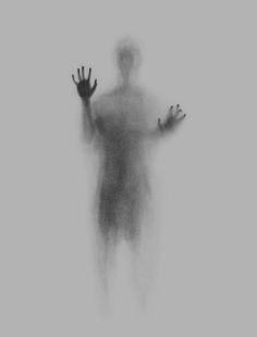 a man standing in the fog with his hands out