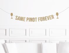 a banner that says same pinot forever hanging from a string in a living room