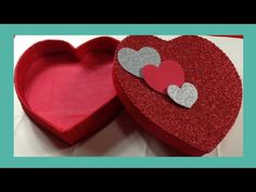 two heart shaped boxes sitting on top of a table