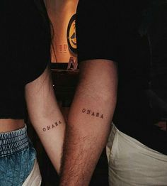 two people with tattoos on their legs and one has the word obama written on it