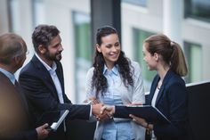 three business people shaking hands with each other