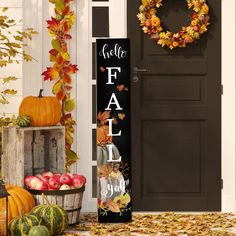 a fall front porch with pumpkins, gourds and an autumn door hanger