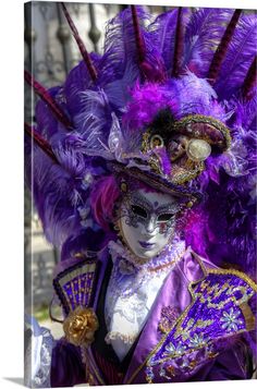 a man wearing a purple mask and feathers on his head in a carnival parade,