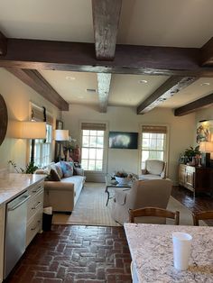 a kitchen and living room are shown in this house's open floorplan