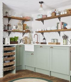 a kitchen filled with lots of open shelves