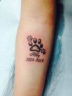 a dog's paw with the birth date tattooed on it