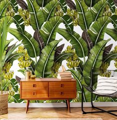 the wallpaper in this room has bananas and other plants on it, as well as a chair