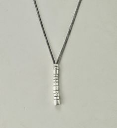 Beautiful, primitive and subtle, this unique piece is a hand cast slightly irregular sterling silver tube that I segment into asymmetrical slices, bevel the edges and finish with a vertical brushed texture. The chain is a beautifully dense and supple sterling foxtail with a striking custom crafted toggle clasp.  Each piece is meticulously hand crafted. Subtle variation is to ne expected. Tube Necklace, Hand Cast, Toggle Clasp, Favorite Things Gift, Minneapolis, Pendant Necklaces, Unique Pieces, Jewelry Necklace Pendant, Hand Crafted