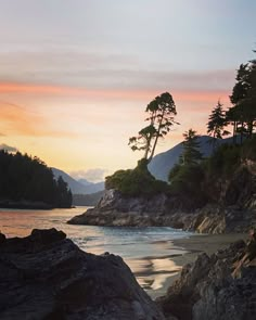 the sun is setting at the beach with trees on the shore and mountains in the background