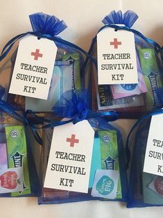 the teacher survival kit is wrapped in blue organine and has four tags attached to it