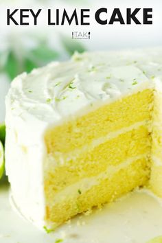 a close up of a slice of cake on a plate with limes in the background