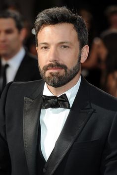 a man with a beard wearing a tuxedo